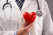 Doctor holding heart against chest