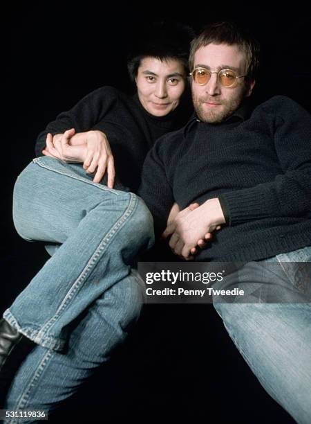 John Lennon and Yoko Ono with cropped hair and matching outfits, 1973.
