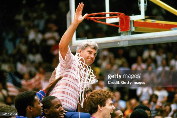 Bobby Knight coach for Indiana University mens basketball cuts down the nets to celebrate a big victory.