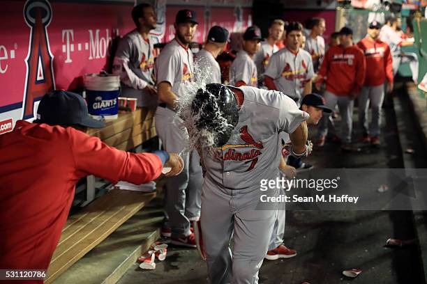 Matt Holliday of the St. Louis Cardinals is splashed with water by Carlos Martinez of the St. Louis Cardinals in the dugout after hitting a solo...