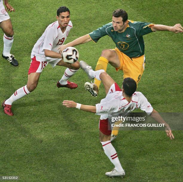 Australian forward Mark Viduka vies with Tunisian defender Anis Ayari during the Confederations cup football match Australia vs Tunisia, 21 June 2005...