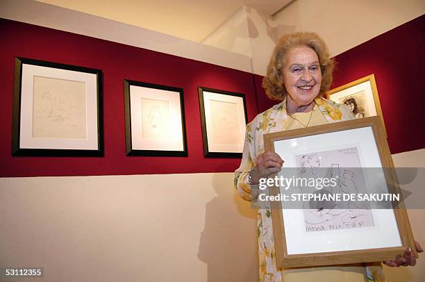 Genevieve Laporte, 79-years-old, holds a portrait of her made by Spnanish artist Pablo Picasso at Hotel Dassault, 21 June 2005 in Paris. Laporte who...