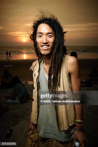 japanese man with dreadlocks on the beach - hippies stock pictures, royalty-free photos & images