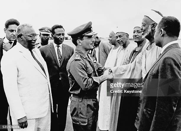 King Hussein of Jordan is welcomed by officials upon his arrival in Khartoum to attend the Arab League Summit, Sudan, August 1967. The summit was...