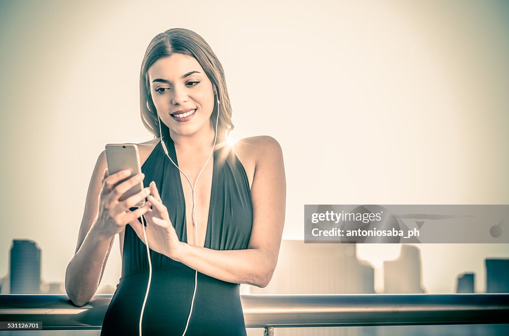 Woman in bathing suit with smartphone