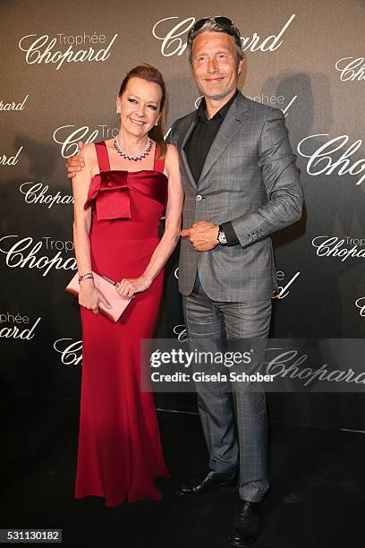 Mads Mikkelsen and Caroline Scheufele arrive at the Chopard Trophy Ceremony at the annual 69th Cannes Film Festival at Hotel Martinez on May 12, 2016...