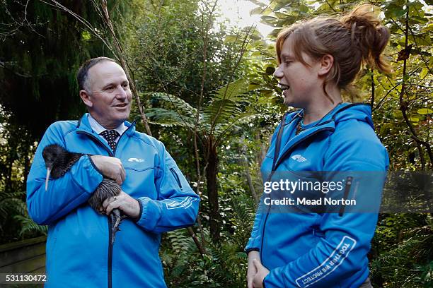 Prime Minister John Key holds 'Mighty Dash', Rainbow Springs 1,500th Kiwi chick while Emma Bean looks during his visit to Ngai Tahu Tourism's Rainbow...