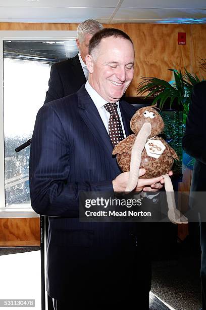 Prime Minister John Key shows off his Kiwi presents given to him during his visit to Ngai Tahu Tourism's Rainbow Springs on May 13, 2016 in Rotorua,...