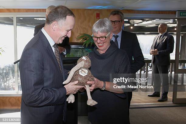 Prime Minister John Key recieves a present from Mayor Stevie Chadwick during his visit to Ngai Tahu Tourism's Rainbow Springs on May 13, 2016 in...