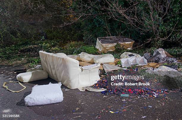 dumped furniture in street at night - garbage dump stock pictures, royalty-free photos & images