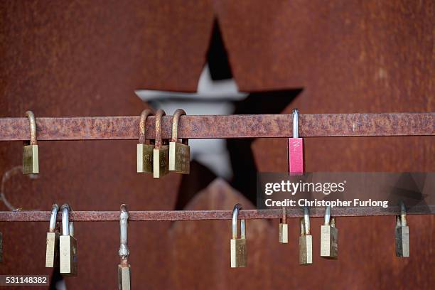 Love padlocks hang from a commemorative sculpture at the dock where the 1985 European Schengen Agreement was signed on May 11, 2016 in Schengen,...