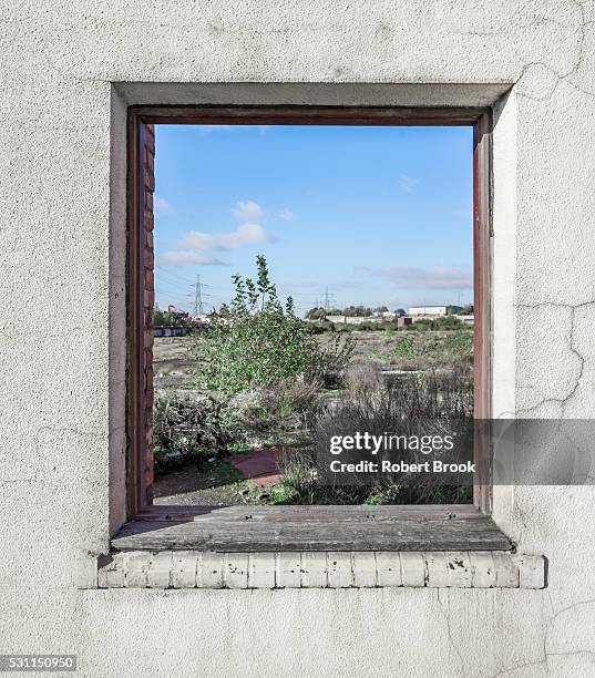 site of former steelworks seen through window of one remaining wall - window frame stock pictures, royalty-free photos & images