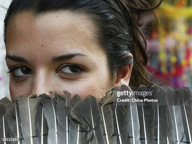 Nikoletta Ralli from Greece poses for pictures with a goose feather fan during a sightseeing activity of 2005 Miss Tourism Queen International...
