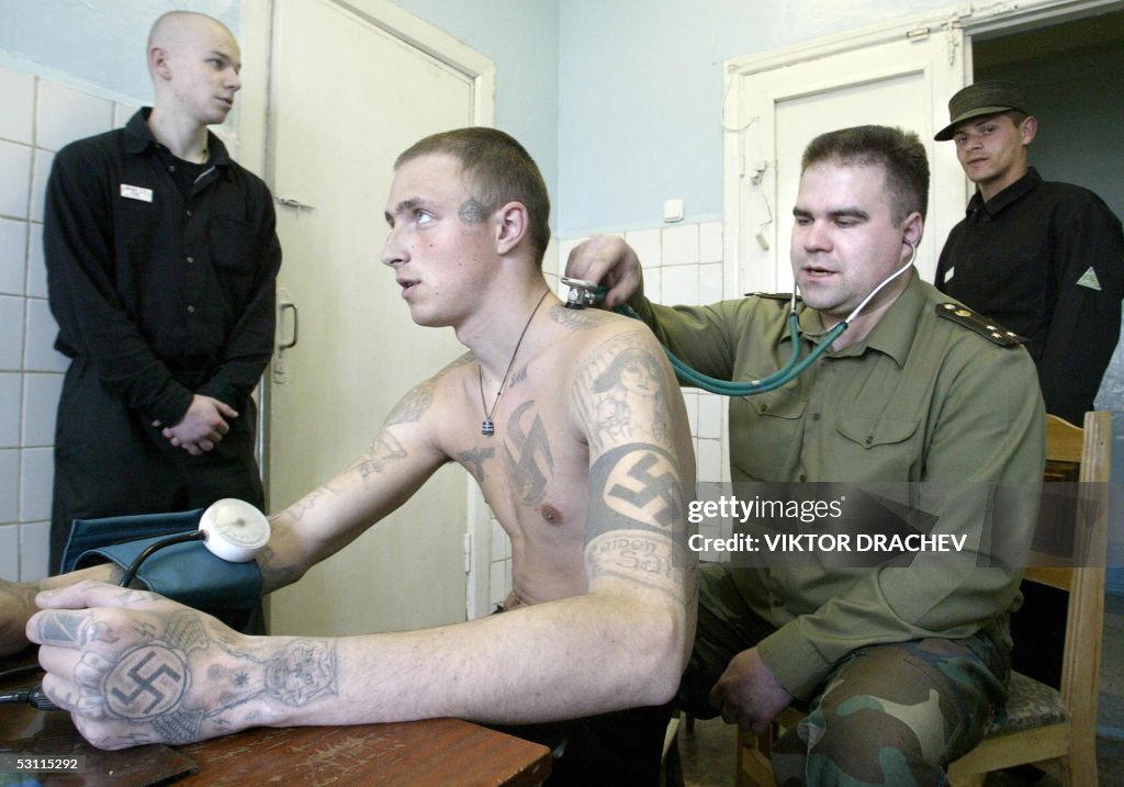 A Belarus prison doctor examines a priso