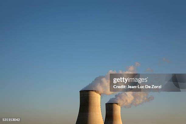 nuclear reactors against blue sky - kühlturm stock-fotos und bilder