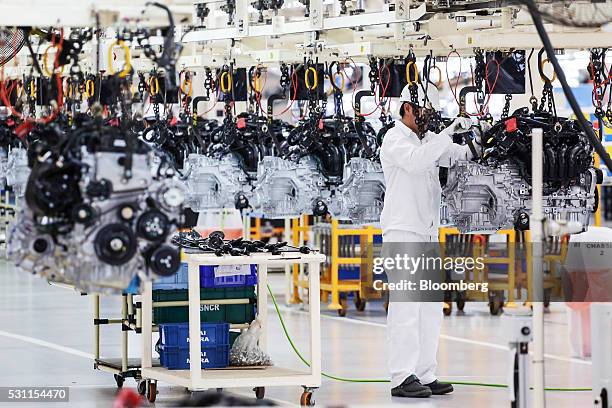 An employee assembles an engine of a Honda Civic vehicle on the production line of the Honda Motor Co. Assembly plant in Prachinburi, Prachinburi...