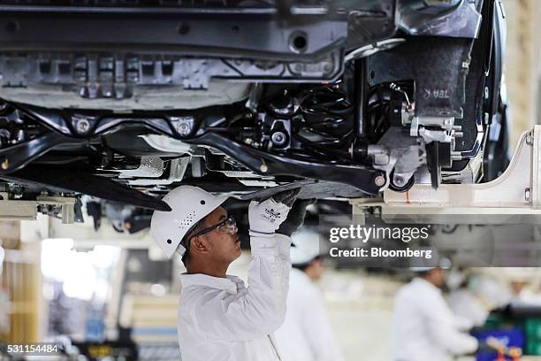 An employee works on Honda Civic vehicles on the production line of the Honda Motor Co. Assembly plant in Prachinburi, Prachinburi Province,...
