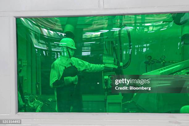 An employees works inside a welding station on Honda Civic vehicles on the production line of the Honda Motor Co. Assembly plant in Prachinburi,...