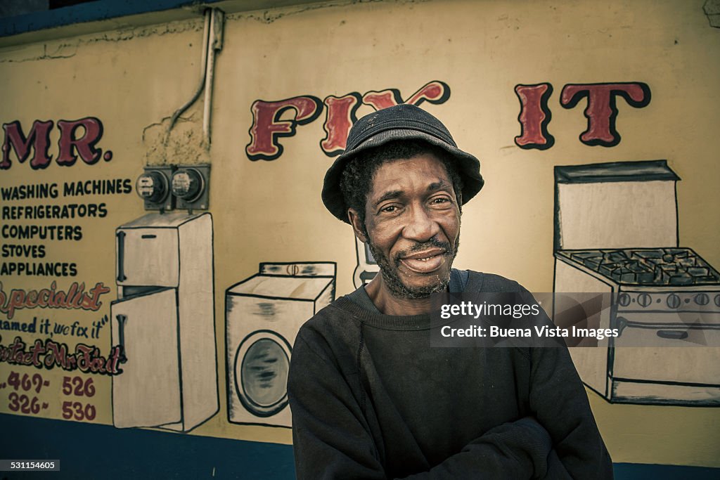 Man in front of his repair shop