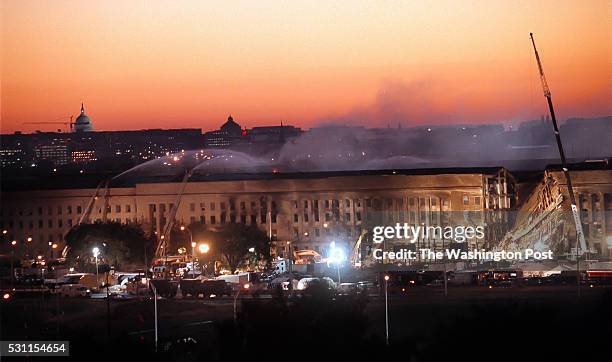 Single day after a commercial plane attacked at Pentagon, Arlington, VA on September 12, 2001. Early morning view of firefighters fighting fires...