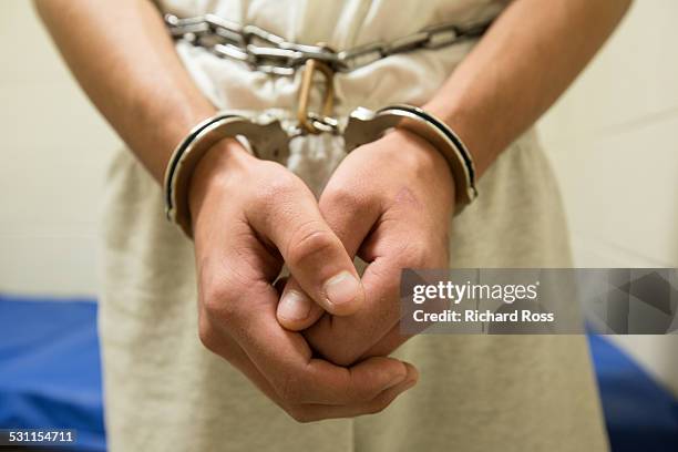 teenage boy in shackles - jail stock pictures, royalty-free photos & images