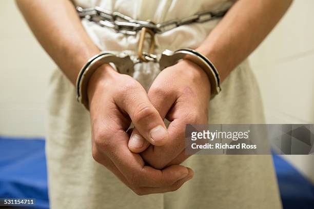 teenage boy in shackles - handcuffs 個照片及圖片檔