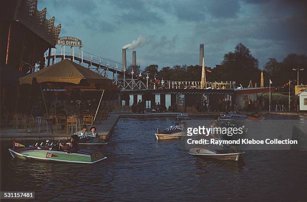 Battersea Fun Fair in Battersea Park, London, with Battersea Power Station visible in the background, circa 1965. The John Collins Big Dipper was the...