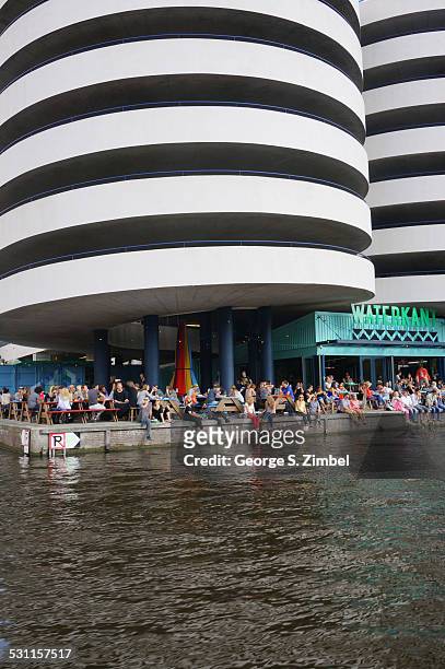 View of a crowd of people on the dock of the canal-fronted Waterkant cafe, Amsterdam, Netherlands, September 14, 2014.