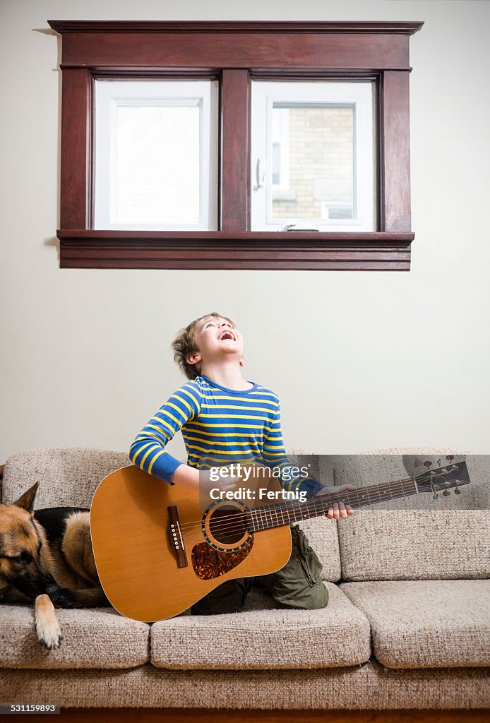 Rocking out on the couch with a guitar