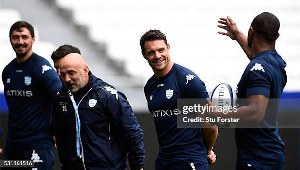 Dan Carter of Racing shares a joke with team mates during the Racing 92 Captain's Run ahead of the European Rugby Champions Cup Final against...