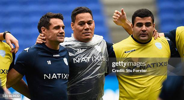 Dan Carter of Racing shares a joke with team mates during the Racing 92 Captain's Run ahead of the European Rugby Champions Cup Final against...