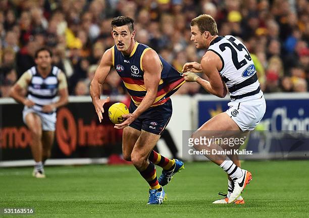 Taylor Walker of the Crows tries to evade a tackle from Jared Rivers of the Cats during the round eight AFL match between the Adelaide Crows and the...