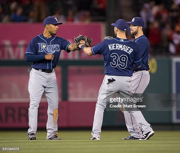 Desmond Jennings, Kevin Kiermaier, and Steven Souza Jr. #20 of the Tampa Bay Rays celebrate after defeating the Los Angeles Angels of Anaheim 4-2 at...
