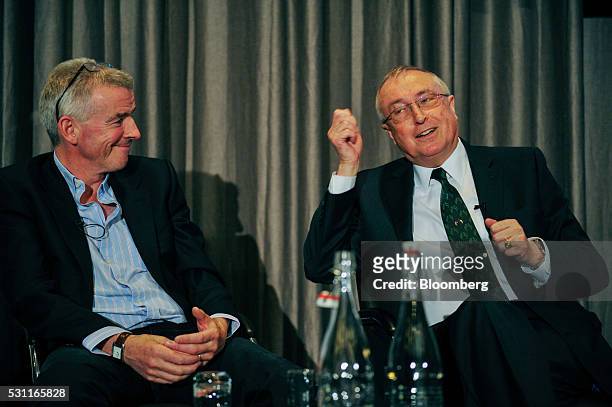 Michael O'Leary, chief executive officer of Ryanair Holdings Plc, left, reacts as Richard Pym, chairman of Allied Irish Banks Plc, speaks during a...