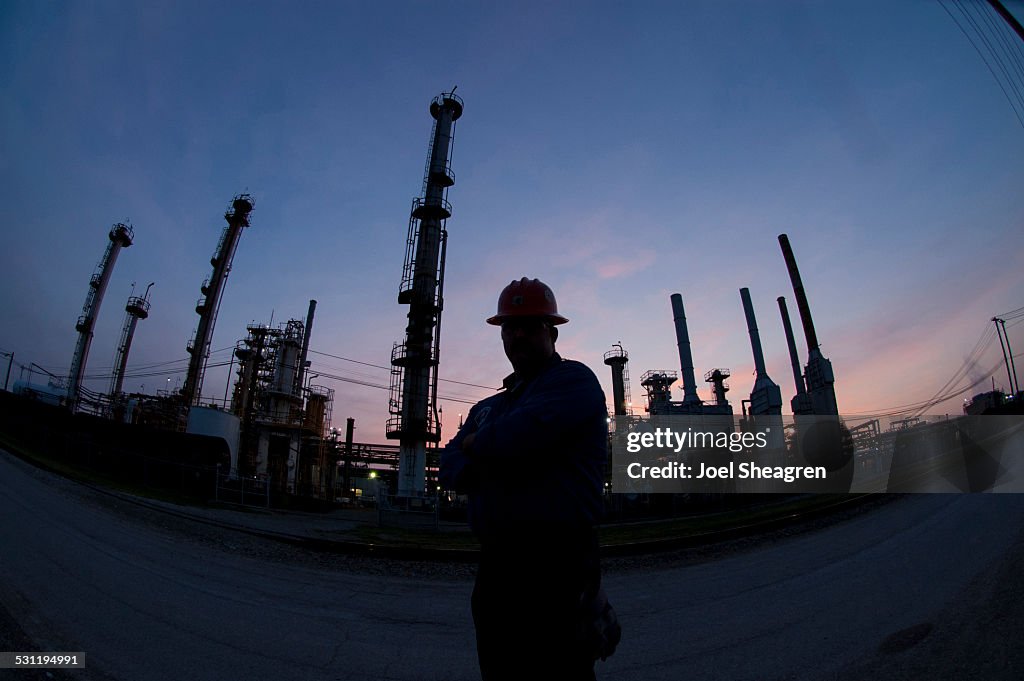 Silhouette of an oil worker in the evening