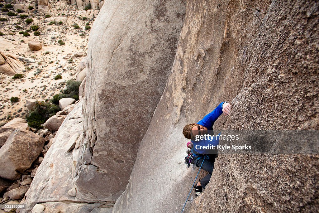 A male climber jams his way up Bird of Fire (5.10a) in Joshua Tree National Park, California.