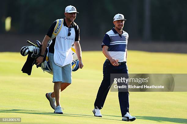 Jonas Blixt of Sweden and caddie Bill Harke prepare to play a shot on the 11th hole during the second round of THE PLAYERS Championship at the...