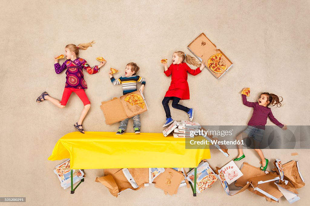 Children eating pizza at party