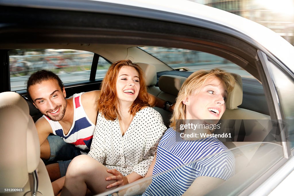 Germany, Berlin, Friends taking a taxi