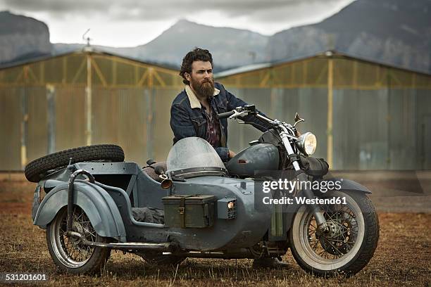 man with full beard in motorcycle with sidecar - rockstar stock-fotos und bilder