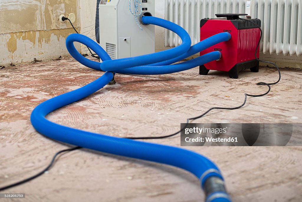 Dehumidifier at work in an apartment which is damaged by flooding
