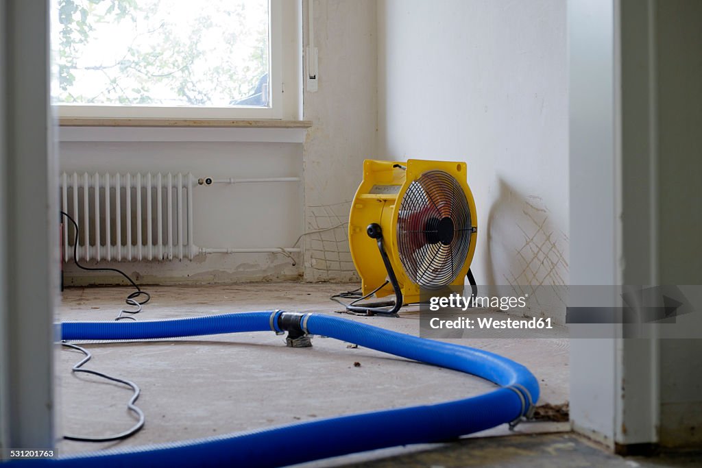 Dehumidifier at work in an apartment which is damaged by flooding