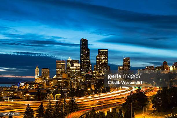 usa, washington state, seattle, dr. jose rizal park, interstate 5 and skyline at blue hour - blue hour stock pictures, royalty-free photos & images