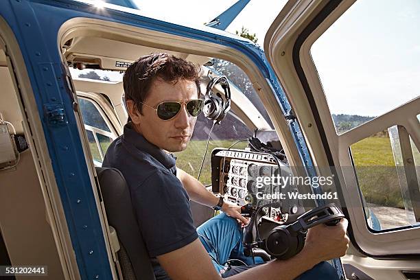 germany, bavaria, landshut, helicopter pilot in cockpit - piloto de helicóptero imagens e fotografias de stock