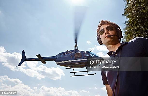 germany, bavaria, landshut, air traffic controller securing landing and take off of helicopoter - helicopter pilot stock pictures, royalty-free photos & images