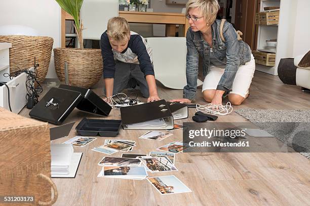 mother and son watching chaos after burglary when coming back in their one-family house - sons of anarchy stock-fotos und bilder