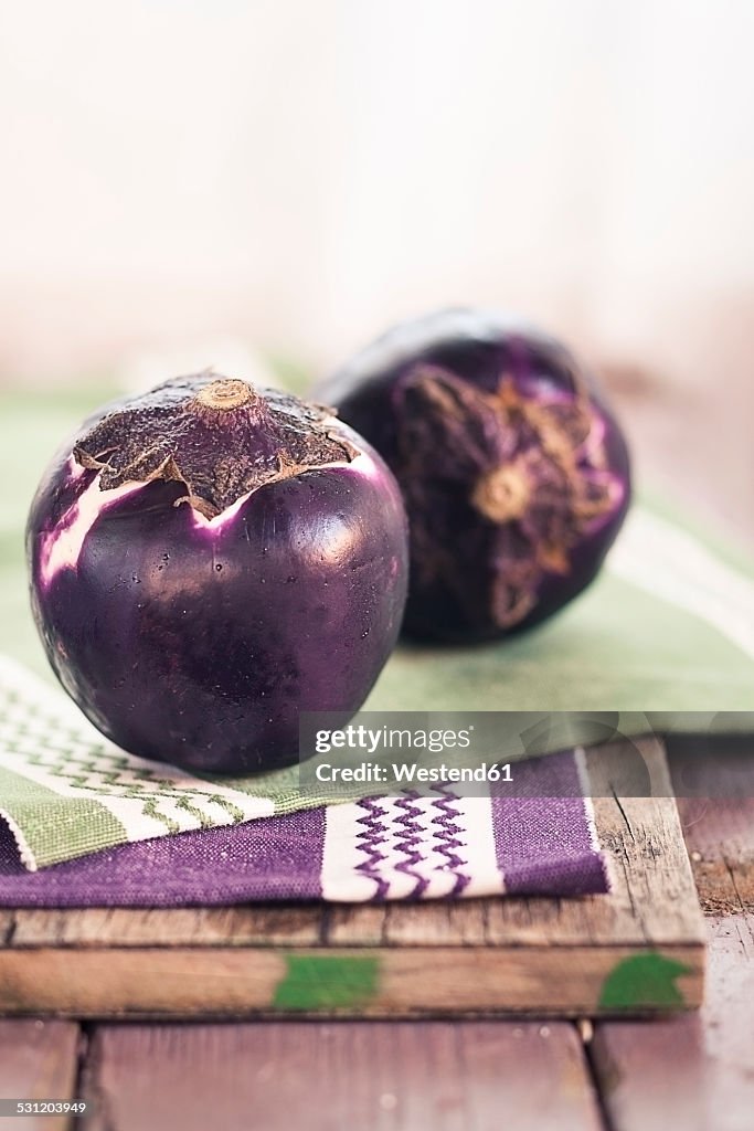Two eggplants, Solanum melongena, on a tray