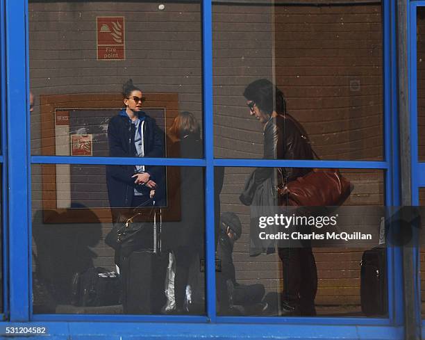 Adam Driver who plays Kylo Ren and Daisy Ridley who plays the character Rey in the Star Wars series can be seen reflected in a window as they hide...