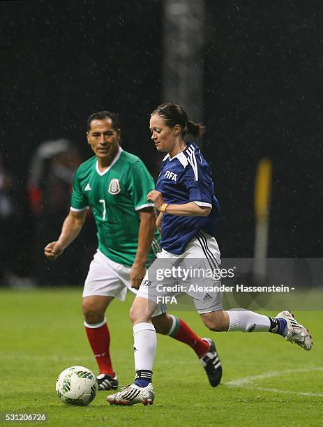 Renate Lingor of FIFA Legends battles for the ball with Benjamin Galindo of MexicanAllstars during an exhibition match between FIFA Legends and...