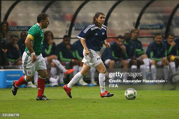 Mia Hamm of FIFA Legends battles for the ball with Alberto Garcia Aspe of MexicanAllstars during an exhibition match between FIFA Legends and...